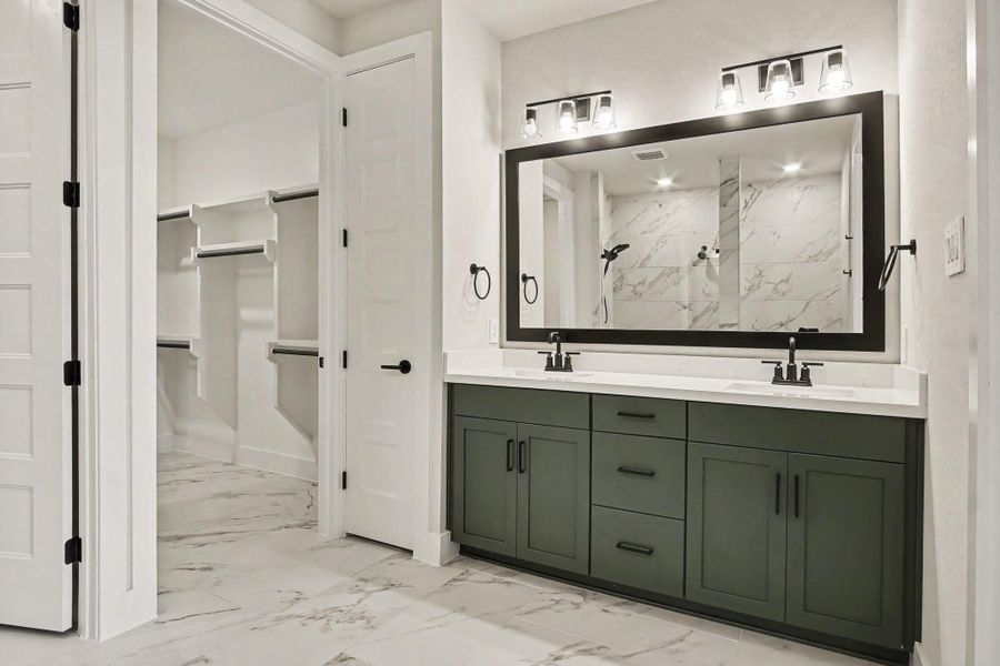 Primary bath with upgraded black, matte hardware, quartz countertop and framed mirror. Primary bath with upgraded black, matte hardware, quartz countertop and framed mirror.