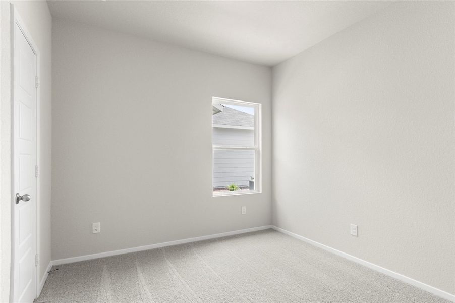 Empty room with light colored carpet and healthy amount of natural light Empty room with light colored carpet and healthy amount of natural light