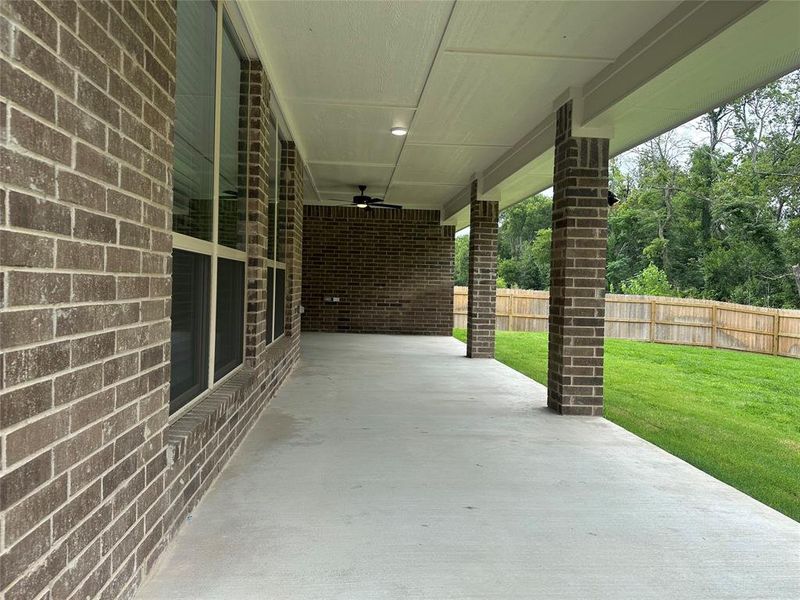 Fenced backyard featuring a patio area and ceiling fan Fenced backyard featuring a patio area and ceiling fan