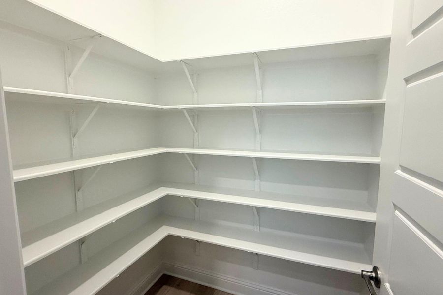 Ample shelving in this walk-in pantry provides exceptional storage and organization potential. Ample shelving in this walk-in pantry provides exceptional storage and organization potential.