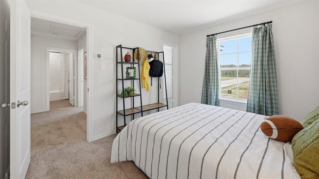 Bedroom featuring light carpet and baseboards Bedroom featuring light carpet and baseboards