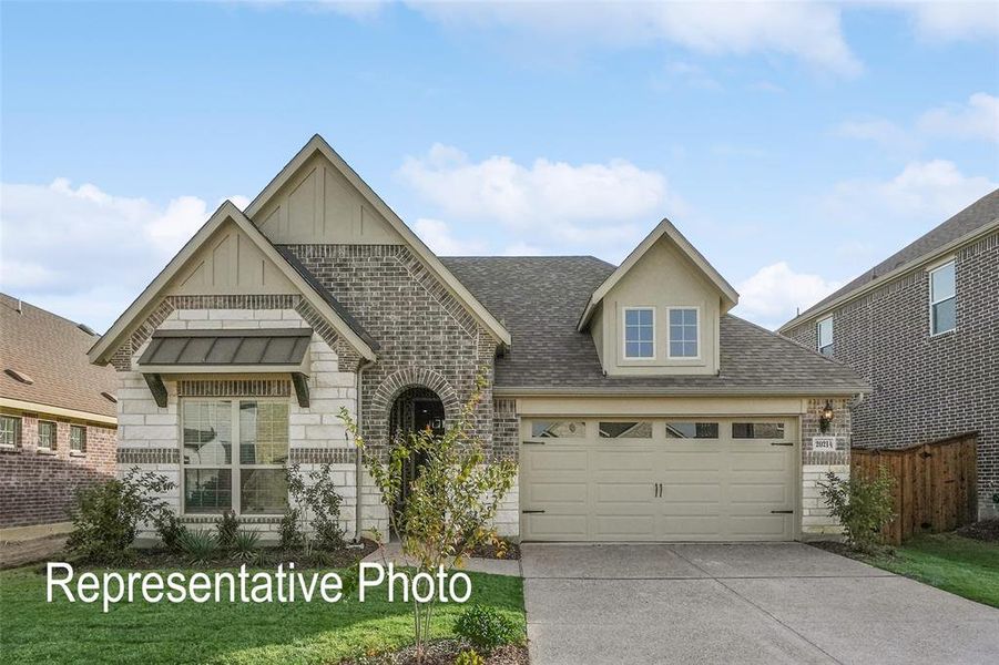 View of front of house featuring a front yard and a garage