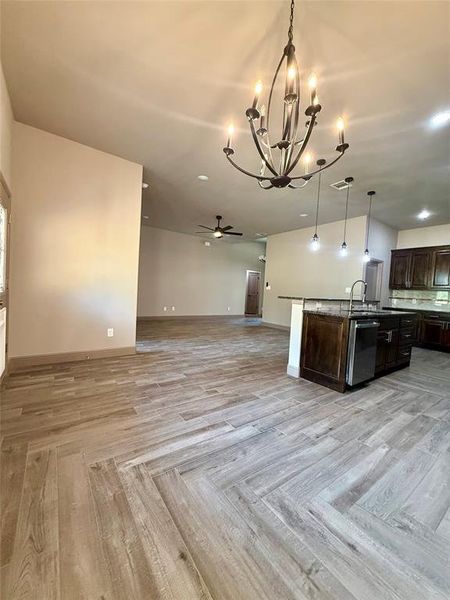 Dining room with chandelier and kitchen for open concept floor plan Dining room with chandelier and kitchen for open concept floor plan