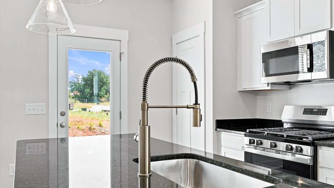 Elegant kitchen with large island and pendant lighting in this first-class DRB Homes design Elegant kitchen with large island and pendant lighting in this first-class DRB Homes design