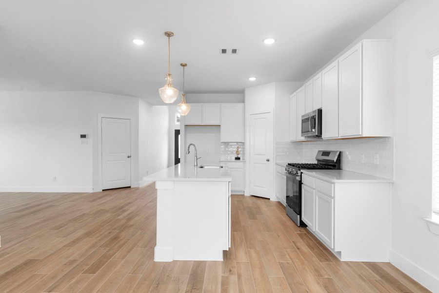 Casual dining is open to the family area and Chef’s kitchen with expansive island, pendant lighting, stainless steel appliances, and ample counter space for meal prep—call today for a private showing!