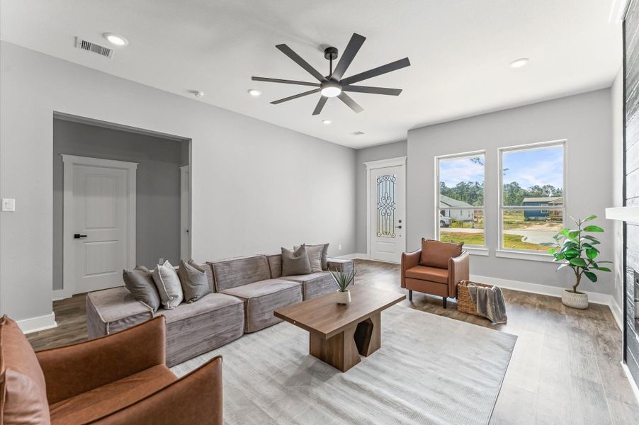 Natural light flows through large windows, accentuating the open layout and laminate flooring throughout. Natural light flows through large windows, accentuating the open layout and laminate flooring throughout.