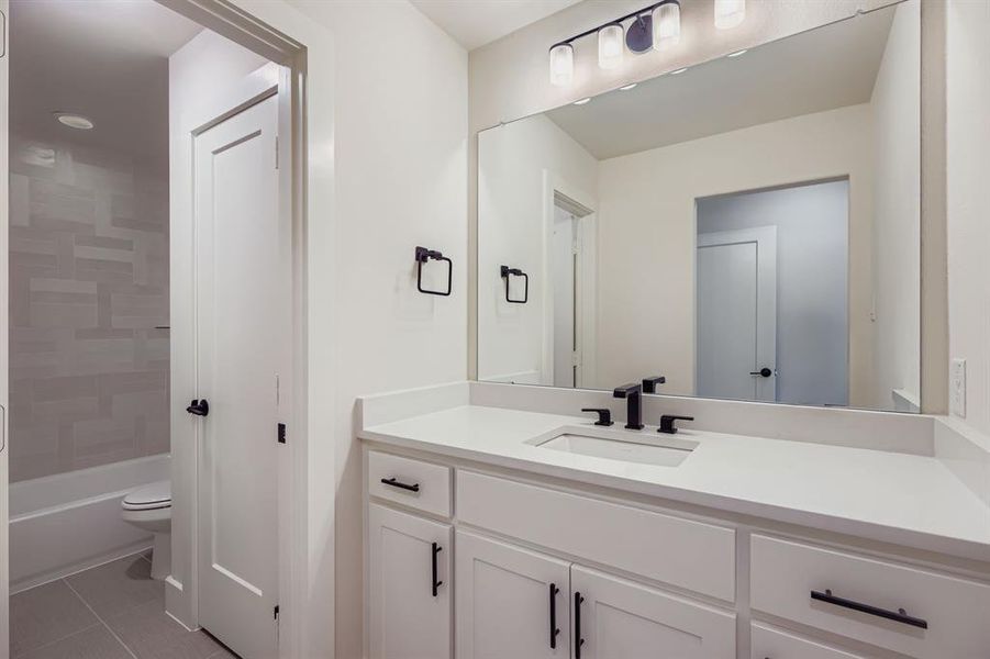 Full bathroom with vanity, tile patterned flooring, and bathtub / shower combination