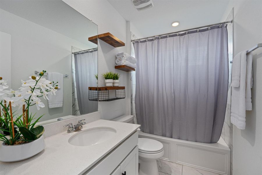 Bathroom with vanity and shower / tub combo