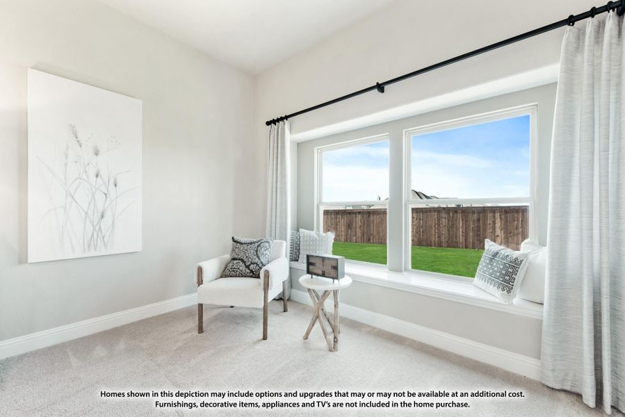 Sitting room with window seat, accent chair, and large windows overlooking a backyard Sitting room with window seat, accent chair, and large windows overlooking a backyard
