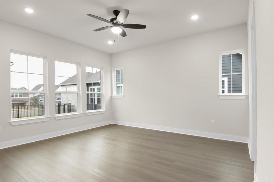 Unfurnished room featuring wood finished floors, a ceiling fan, and recessed lighting