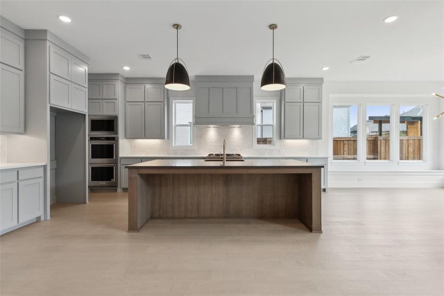 The oversized kitchen island creates the perfect gathering place for friends and family.