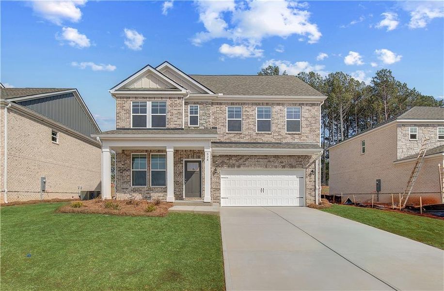 Front exterior of a new home in Bowers Farm, McDonough, GA, highlighting curb appeal (Image 14). Front exterior of a new home in Bowers Farm, McDonough, GA, highlighting curb appeal (Image 14).