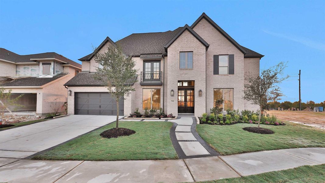 Front exterior of a new home in Elyson 70', Katy, TX, highlighting curb appeal (Image 11). Front exterior of a new home in Elyson 70', Katy, TX, highlighting curb appeal (Image 11).