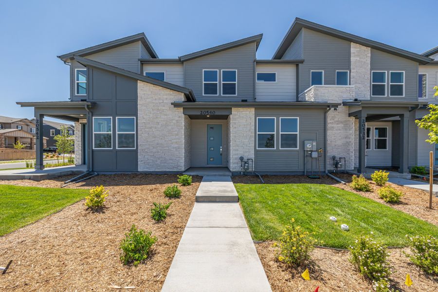 Front exterior of a new home in Painted Prairie, Aurora, CO, highlighting curb appeal (Image 1).