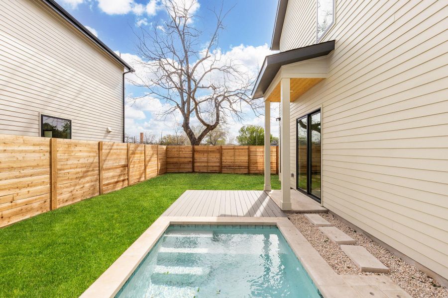 View of pool featuring a fenced backyard and a wooden deck View of pool featuring a fenced backyard and a wooden deck