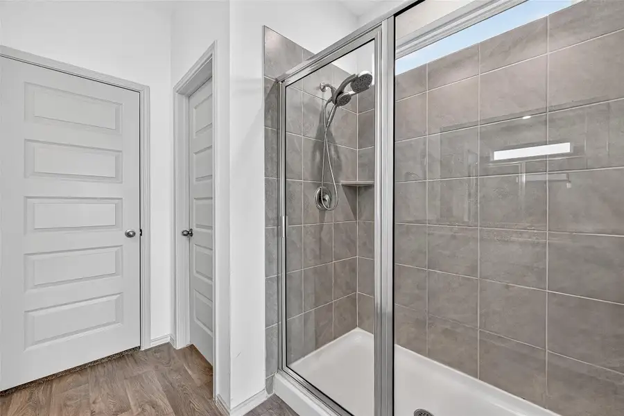 The primary ensuite bath has a large shower and walk-in closet.