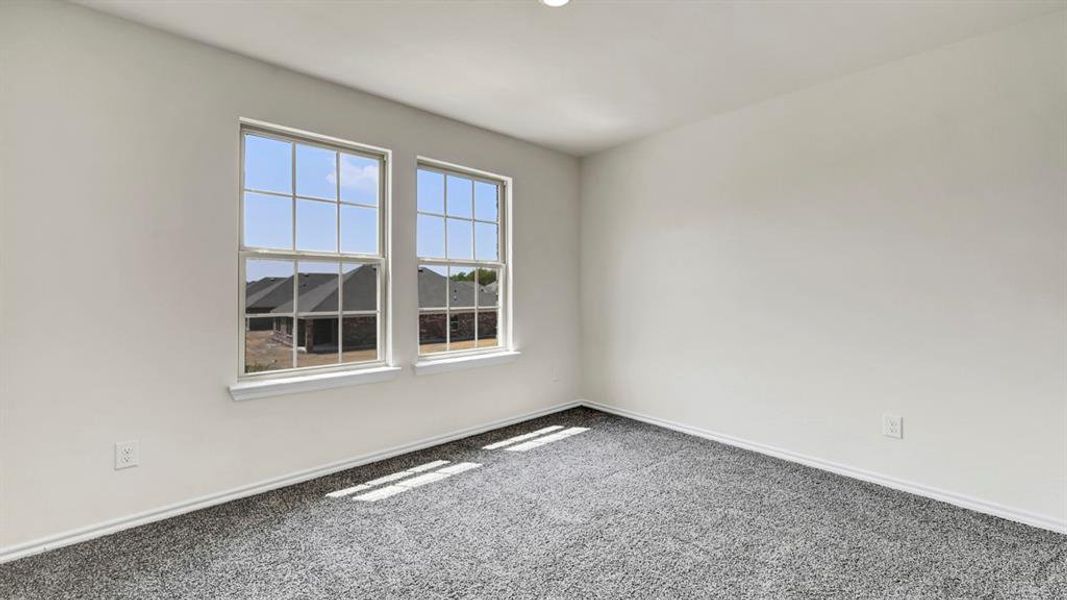 Room featuring two double-hung windows, light gray walls, dark gray carpet, white baseboards, and a recessed ceiling light