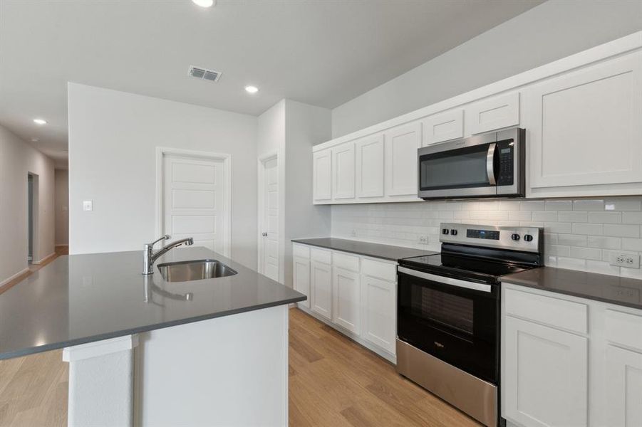 Kitchen in the Hayden home plan by Trophy Signature Homes – REPRESENTATIVE PHOTO Kitchen in the Hayden home plan by Trophy Signature Homes – REPRESENTATIVE PHOTO
