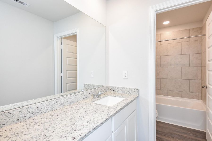 Large, attractive, earth-colored subway style tile fills the combined shower/bathtub in this secondary bath. Large, attractive, earth-colored subway style tile fills the combined shower/bathtub in this secondary bath.