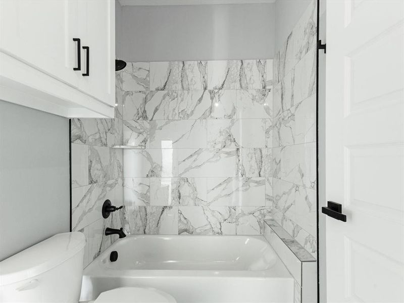 Full bathroom featuring toilet and shower / tub combination