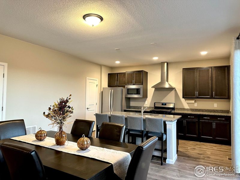 Chef's kitchen with multiple upgrades, soft close cabinets and drawers, granite counters, walk-in pantry, and stainless appliances. Gas range/oven, microwave, dishwasher, and french door refrigerator all stay!