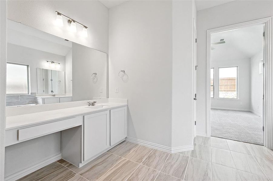 Bathroom featuring vanity and tile patterned flooring