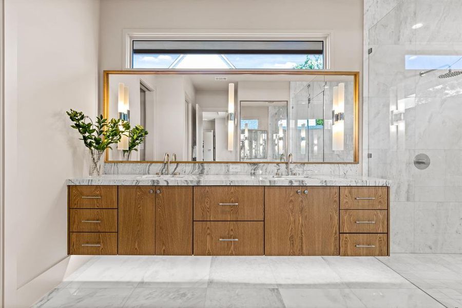 Bathroom featuring vanity, a tile shower, and healthy amount of natural light Bathroom featuring vanity, a tile shower, and healthy amount of natural light
