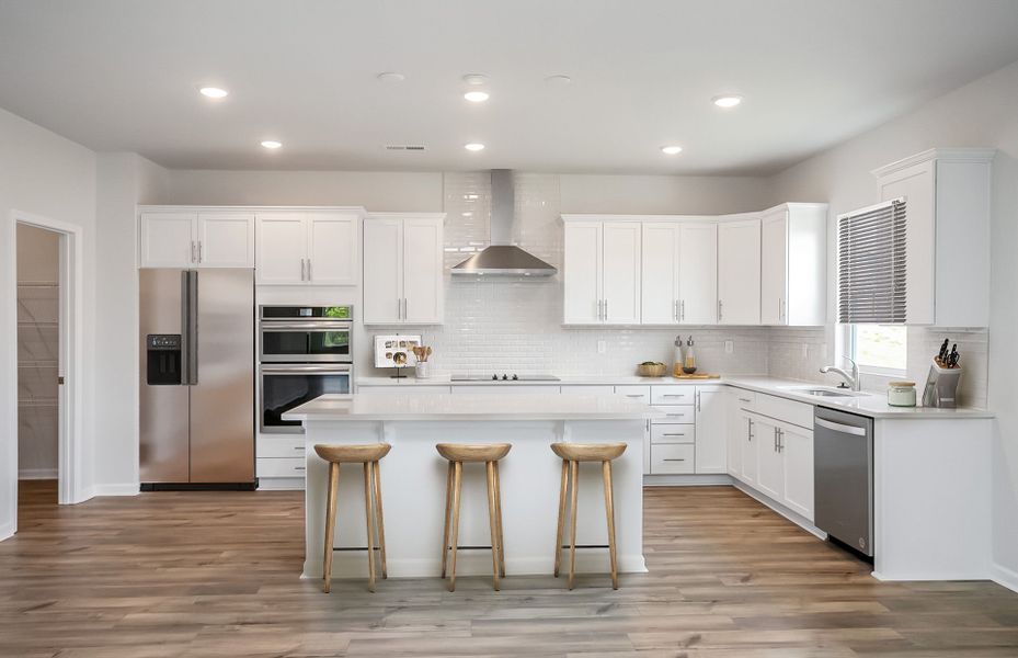 Large kitchen with premium countertops and modern soft close drawers.