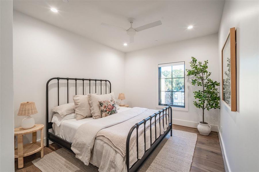 Bedroom featuring dark hardwood / wood-style floors and ceiling fan