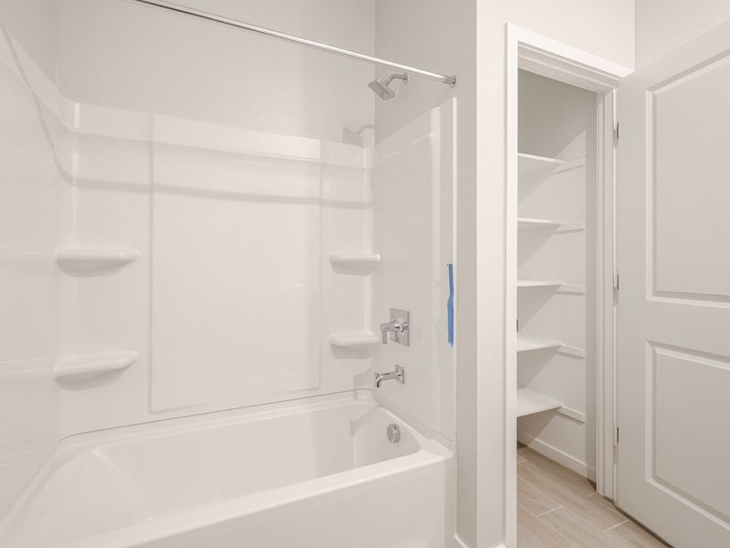 A bathroom with a white shower.