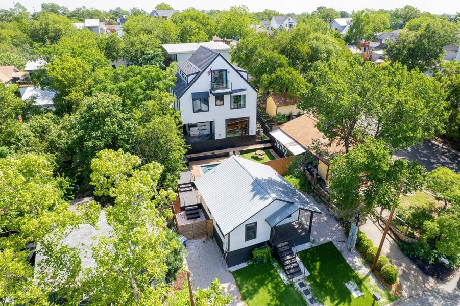 Aerial view of residential area featuring a tree filled landscape