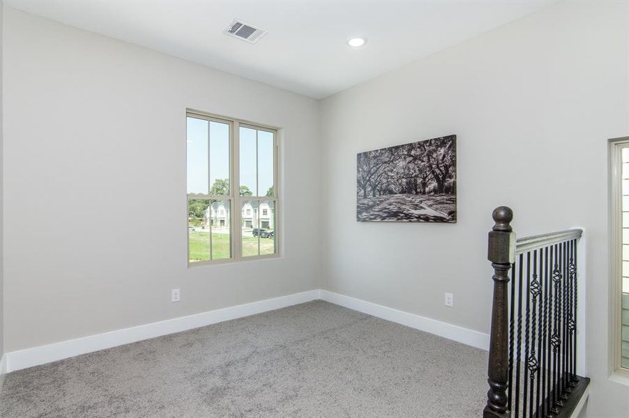 This is a flex space at the top of the stairs which can be used for an office, nursery, sitting area, or whatever you want!