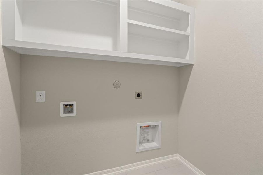 The laundry room layout is carefully planned for optimal workflow with designated areas for washing, drying, and storing.