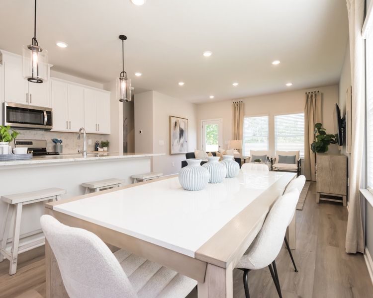 Gather the family around the dining table, at the heart of the open-concept living area.