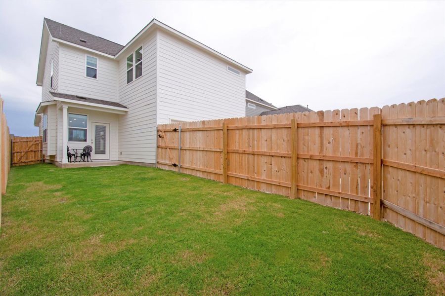 Exterior details and patio area of a home in The Cottages at Lariat, Liberty Hill (Image 13).