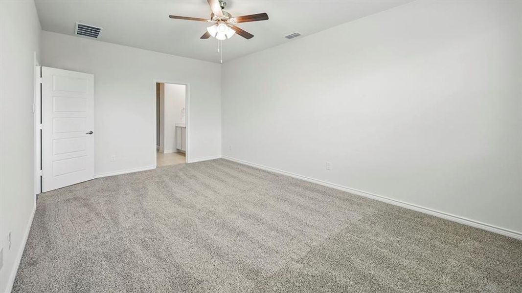 Unfurnished bedroom featuring carpet, ceiling fan, and ensuite bath Unfurnished bedroom featuring carpet, ceiling fan, and ensuite bath