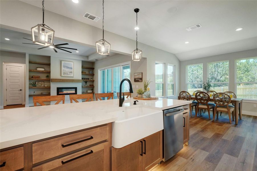 Spacious kitchen island with a farmhouse sink and light-toned countertop