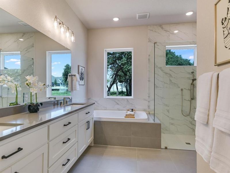 The spa-inspired primary bathroom features a soaking tub and walk-in shower.