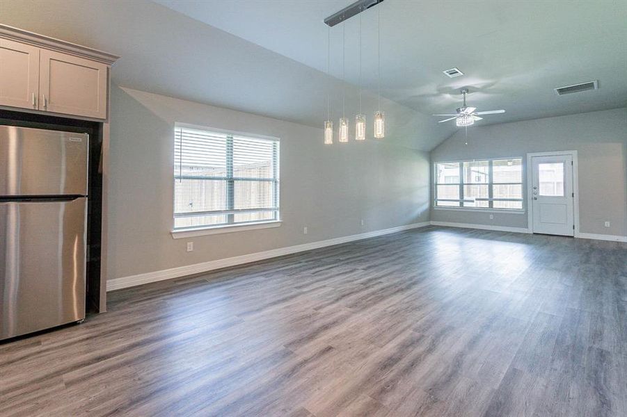 Open living area with vaulted ceiling and designer lighting - light and bright !