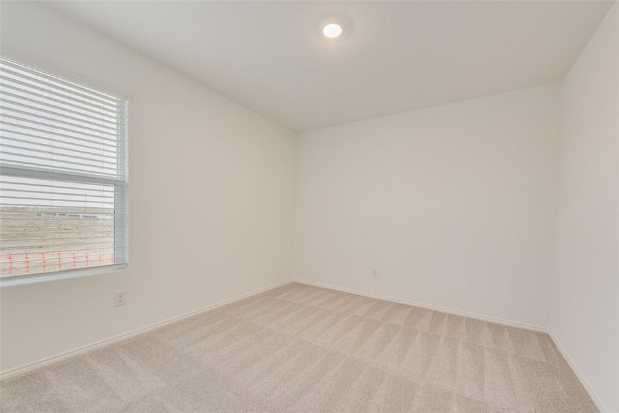 Spare room featuring light colored carpet