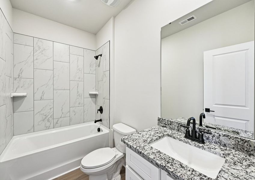 This secondary bathroom includes a beautifully tiled shower This secondary bathroom includes a beautifully tiled shower