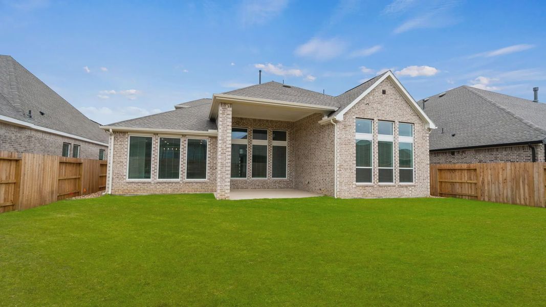Exterior details and patio area of a home in Lakes of Cane Island, Katy (Image 3).