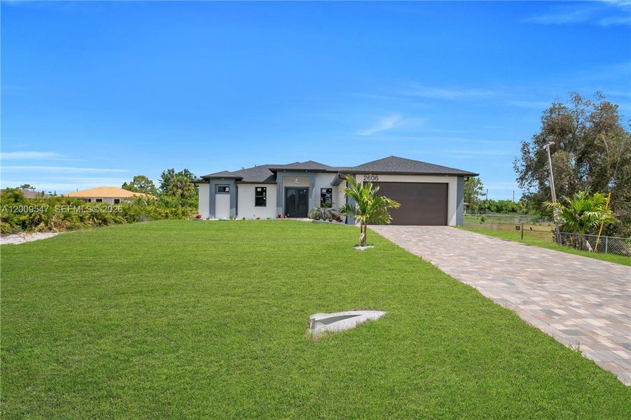 Front exterior of a new home in , Lehigh Acres, FL, highlighting curb appeal (Image 25).