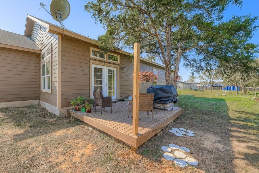 Wooden deck featuring french doors and grilling area Wooden deck featuring french doors and grilling area