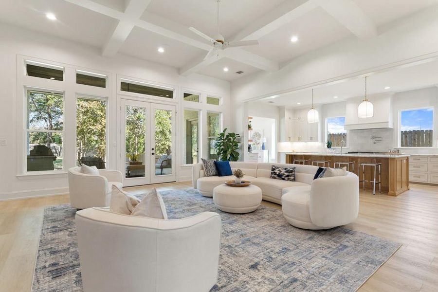 Living room with light wood-style floors, beam ceiling, recessed lighting, a ceiling fan, and french doors
