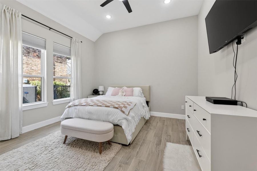 Spacious secondary bedroom featuring large windows and ceiling fan. Spacious secondary bedroom featuring large windows and ceiling fan.