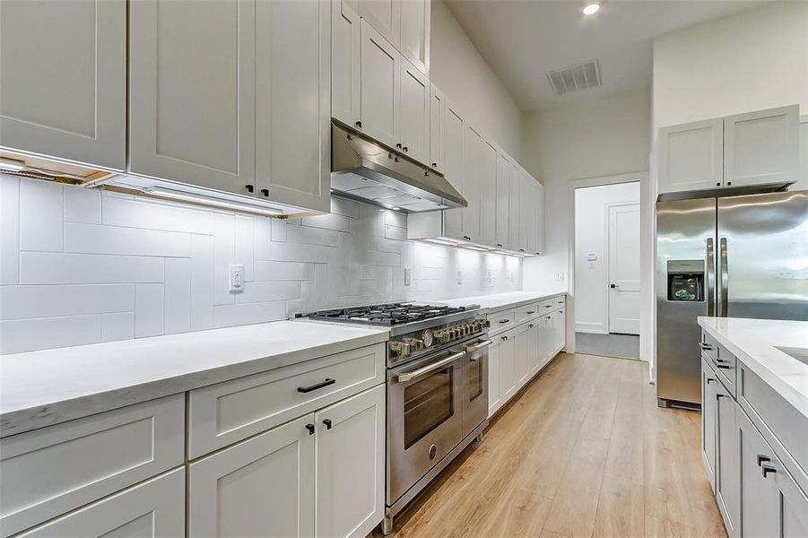 There is ample amounts of storage space for every piece of serving wear, dish, utensil and small appliance in this kitchen.