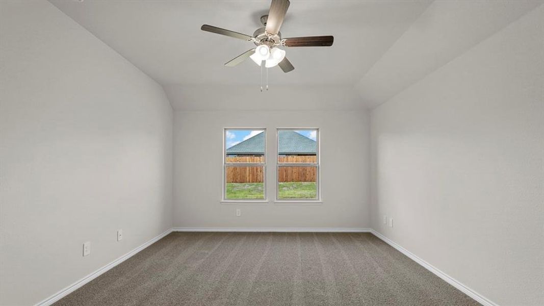 Carpeted room featuring dual windows, a ceiling fan with integrated lighting, and neutral wall tones