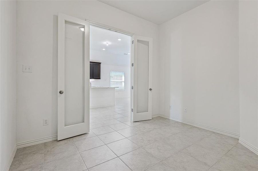 Unfurnished room with french doors and light tile patterned floors