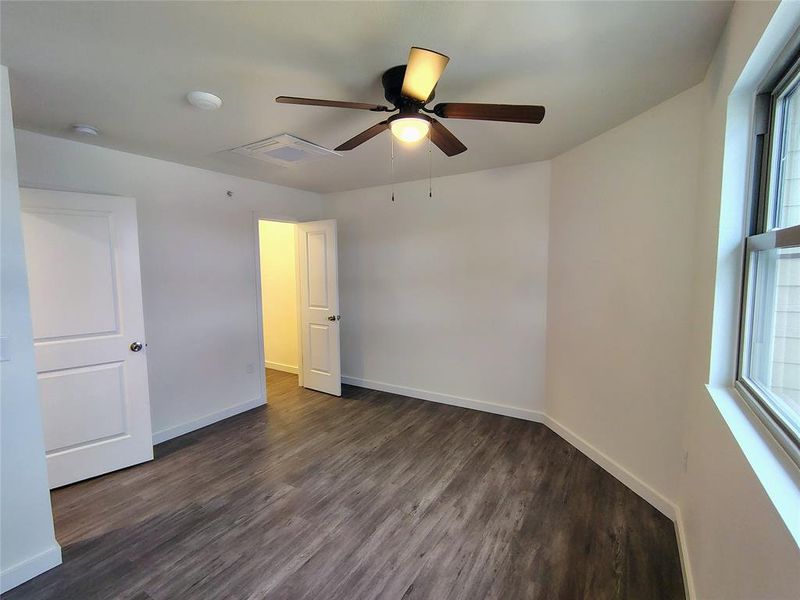 Spare room featuring ceiling fan and dark hardwood / wood-style floors